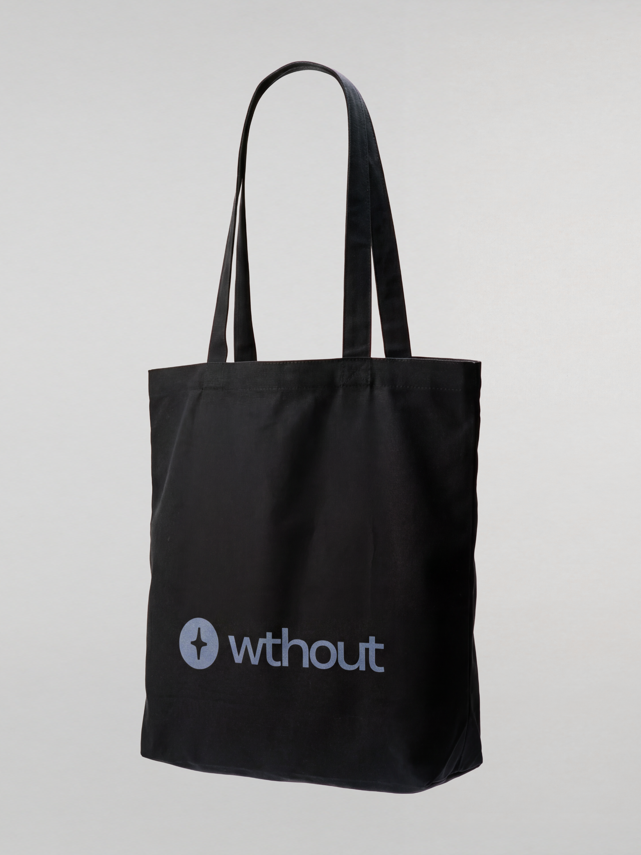 Black tote bag with 'wthout' logo on a light gray background