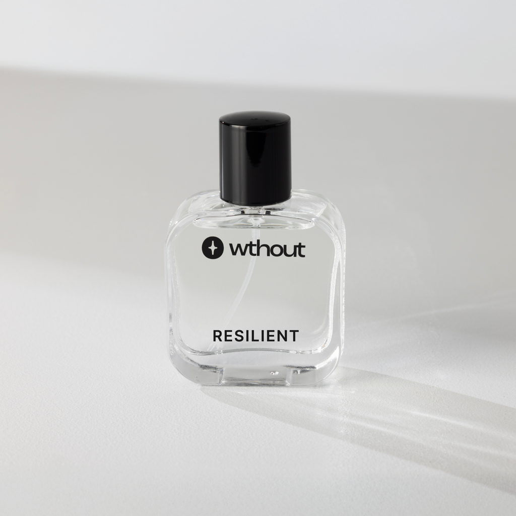 Clear perfume bottle labeled 'without' with 'RESILIENT' on a light gray background